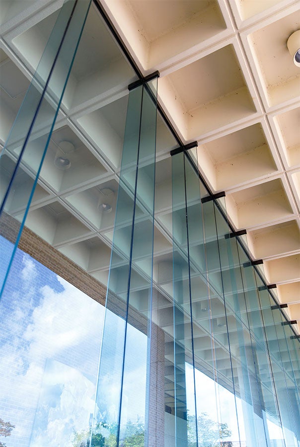 Up close photo of light blue glass windows and architectural details