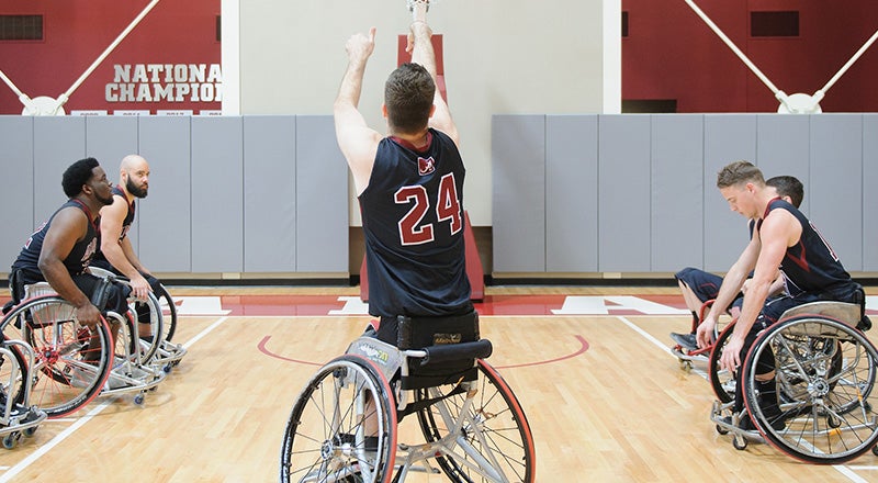 a wheelchair basketball player shoots a free throw