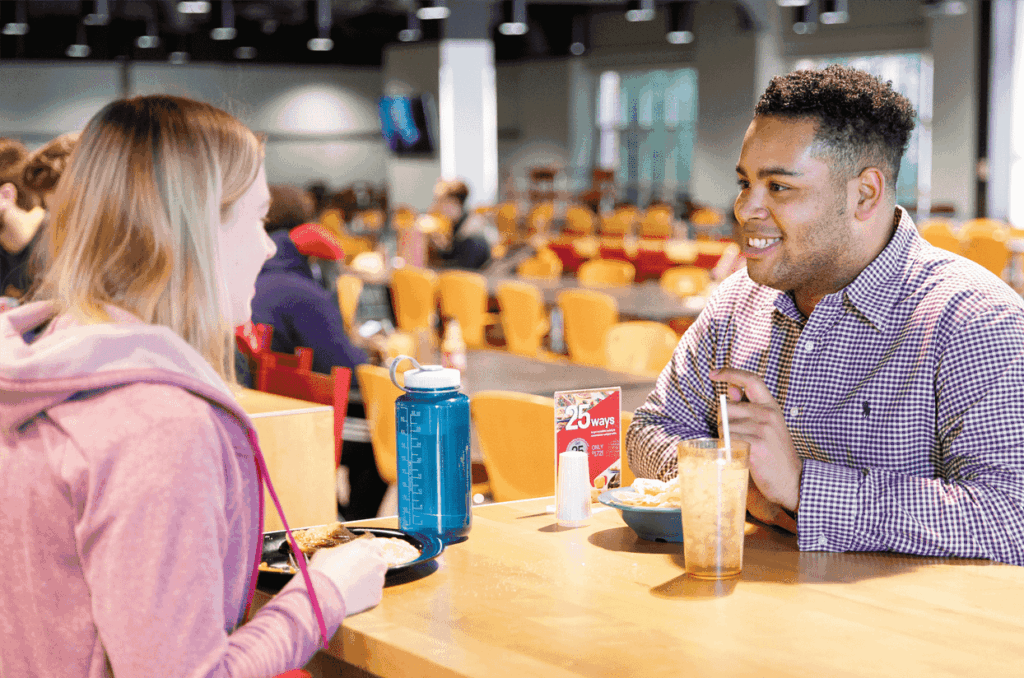 Two students eating lunch in a campus dining facility