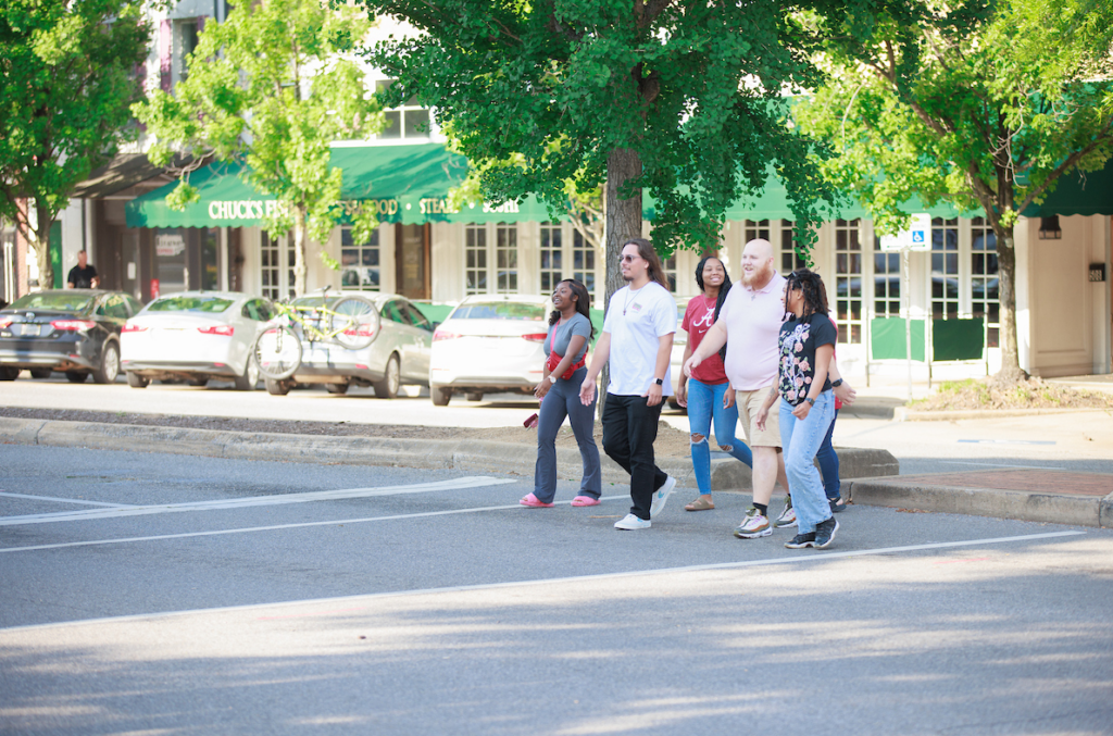 Students crossing a street in downtown Tuscaloosa.