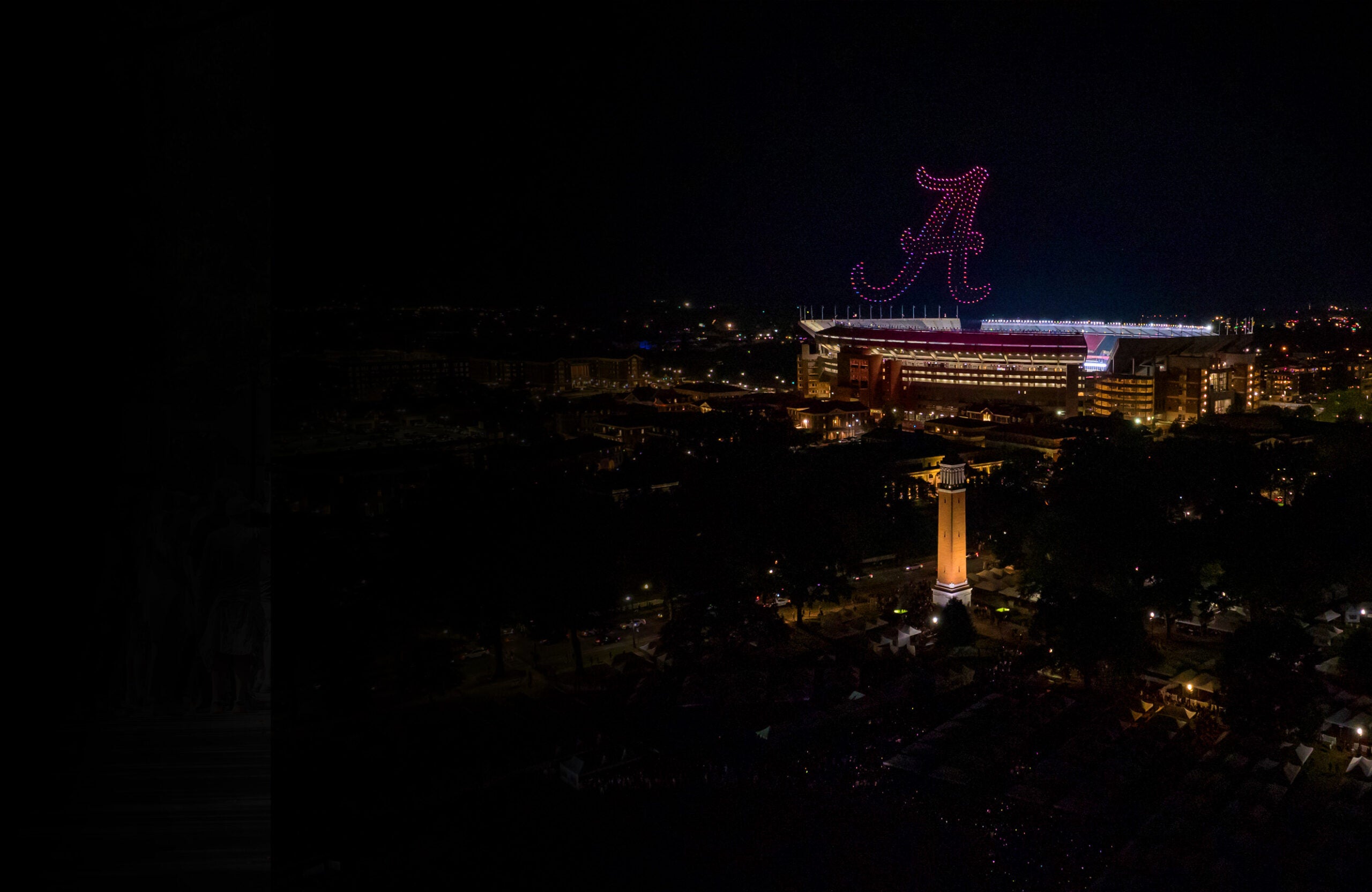 Aerial view of light drone show over campus