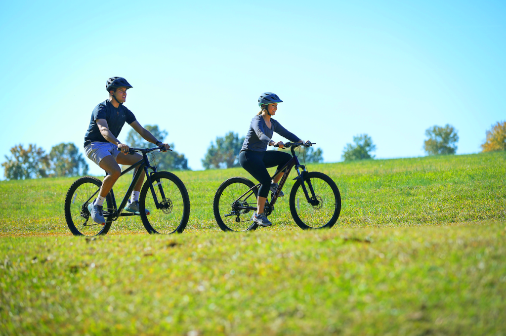 Students riding bicycles on a beautiful day.